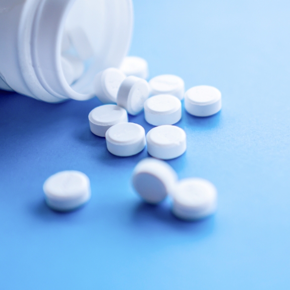 Bottle of white pills spilling out