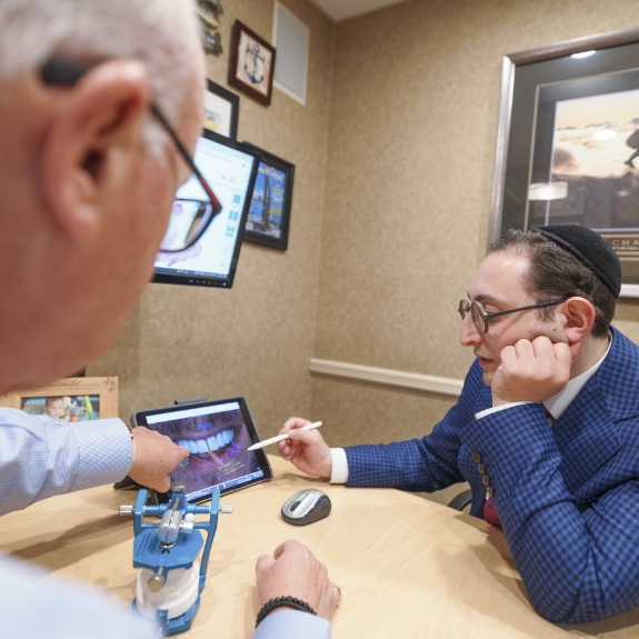Doctor Mohr and Doctor Ariel discussing a photo of a patient's teeth