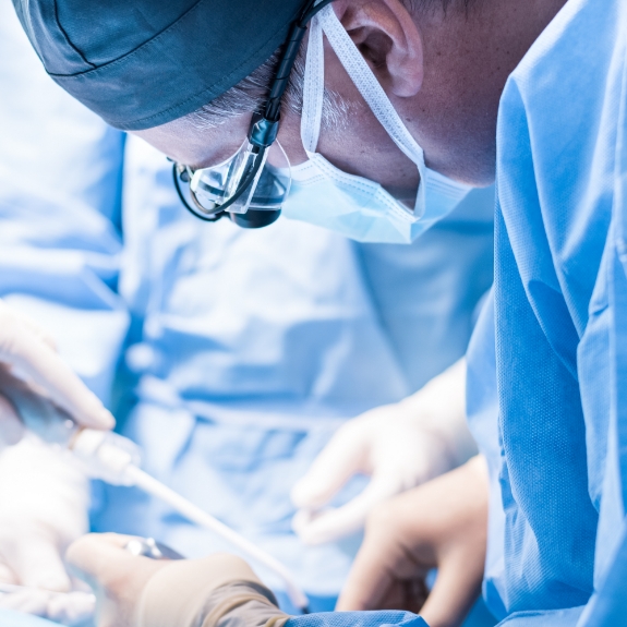 Dental professional performing dental implant surgery on a patient