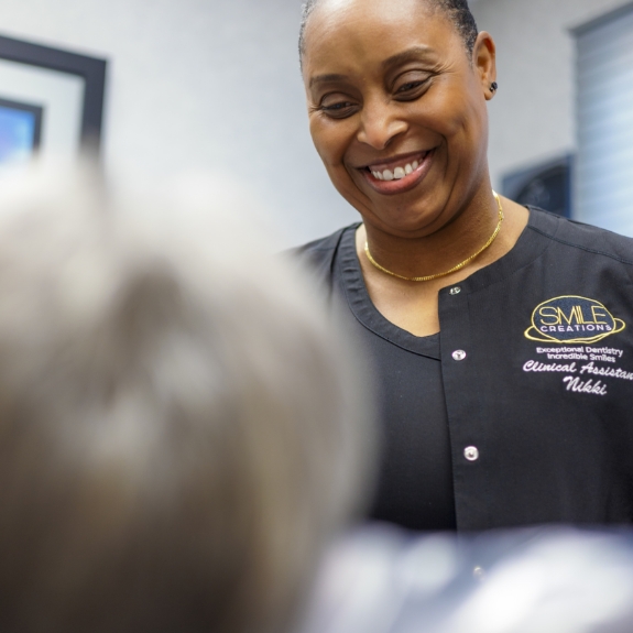 Smile Creations team member grinning at a patient