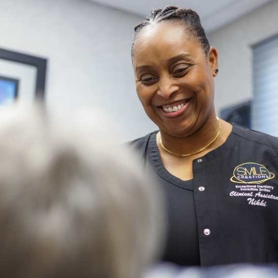 Smile Creations team member grinning at a patient