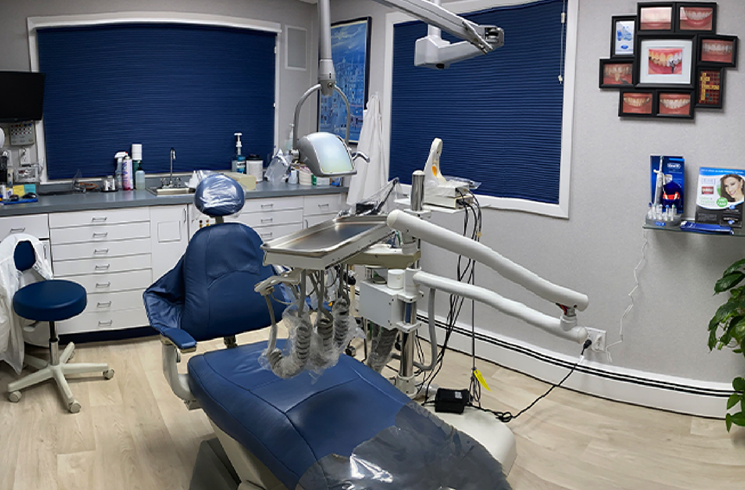 Dental exam room with dark blue blinds drawn
