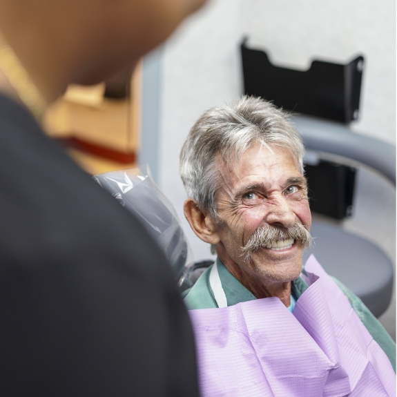 Senior man smiling in the dental chair