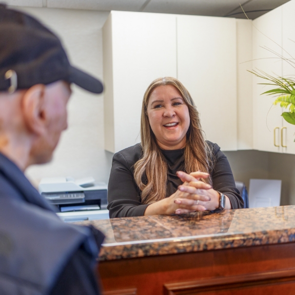 Man checking in at dental office front desk
