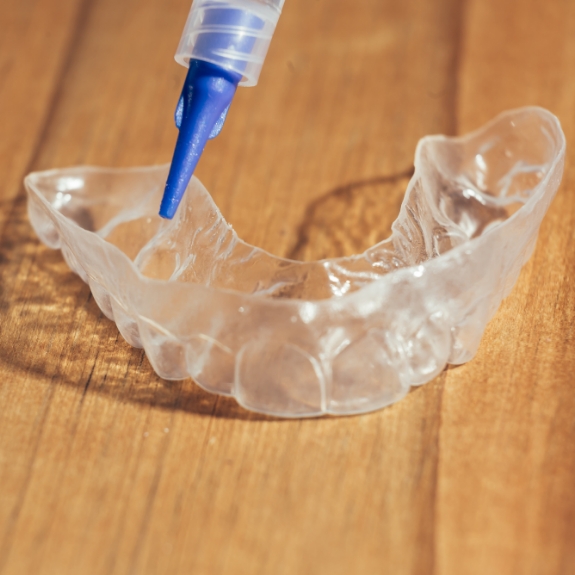 Applicator and a teeth whitening tray