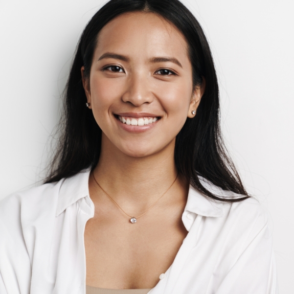 Woman with long dark hair smiling