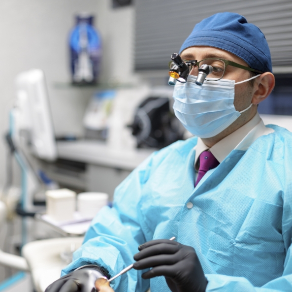 Doctor Ariel wearing personal protective equipment while treating a patient