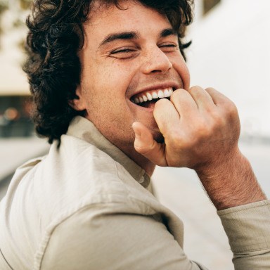 Young man with veneers smiling and laughing