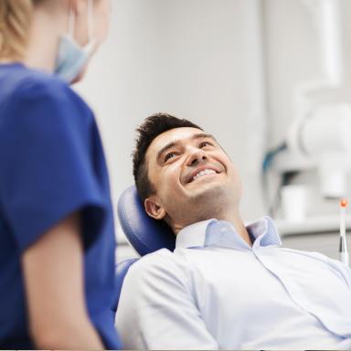 Man talking to assistant about cosmetic dentistry