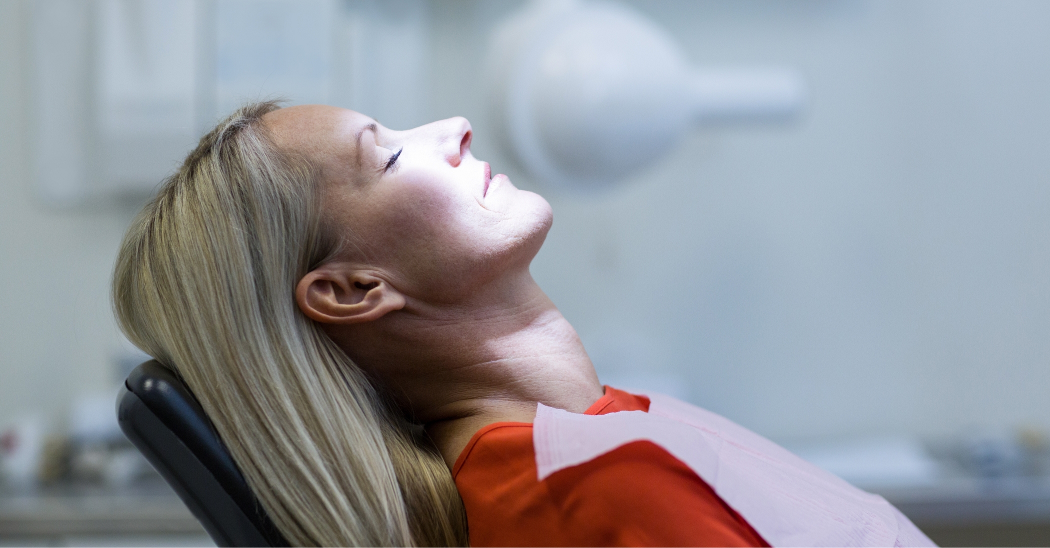 Woman relaxing in the dental chair thanks to nitrous oxide sedation dentistry in Massapequa Park