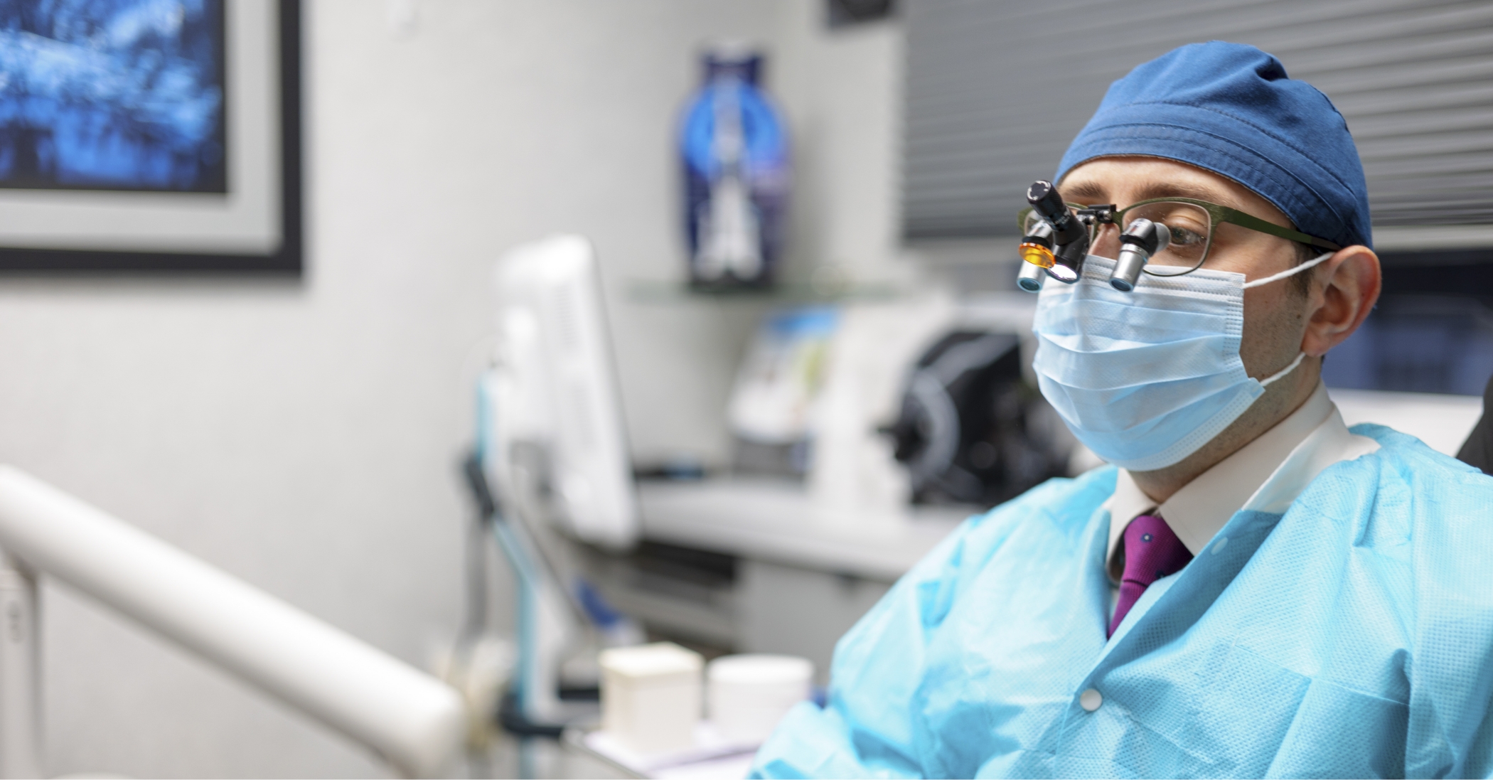 Doctor Ariel performing an oral cancer screening on a Massapequa Park dental patient