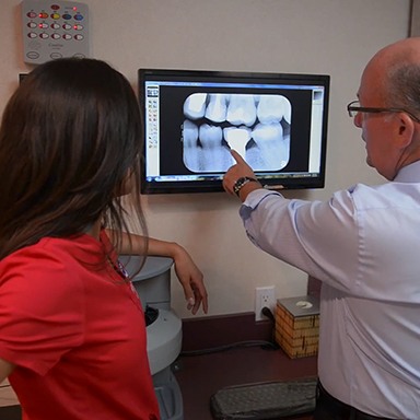 Dr. Mohr showing x-rays to patient