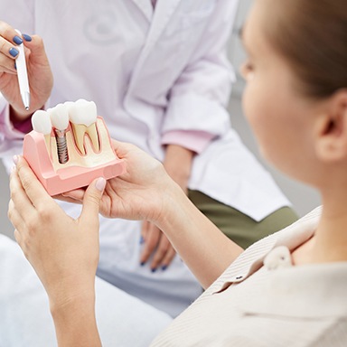 Dentist explaining dental implant failure to a patient 