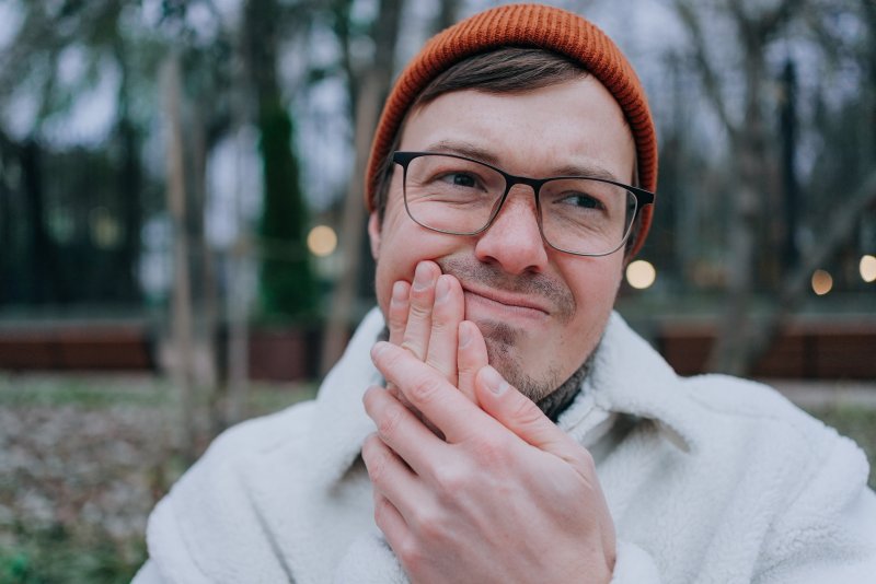 young man with a sensitive dental implant 